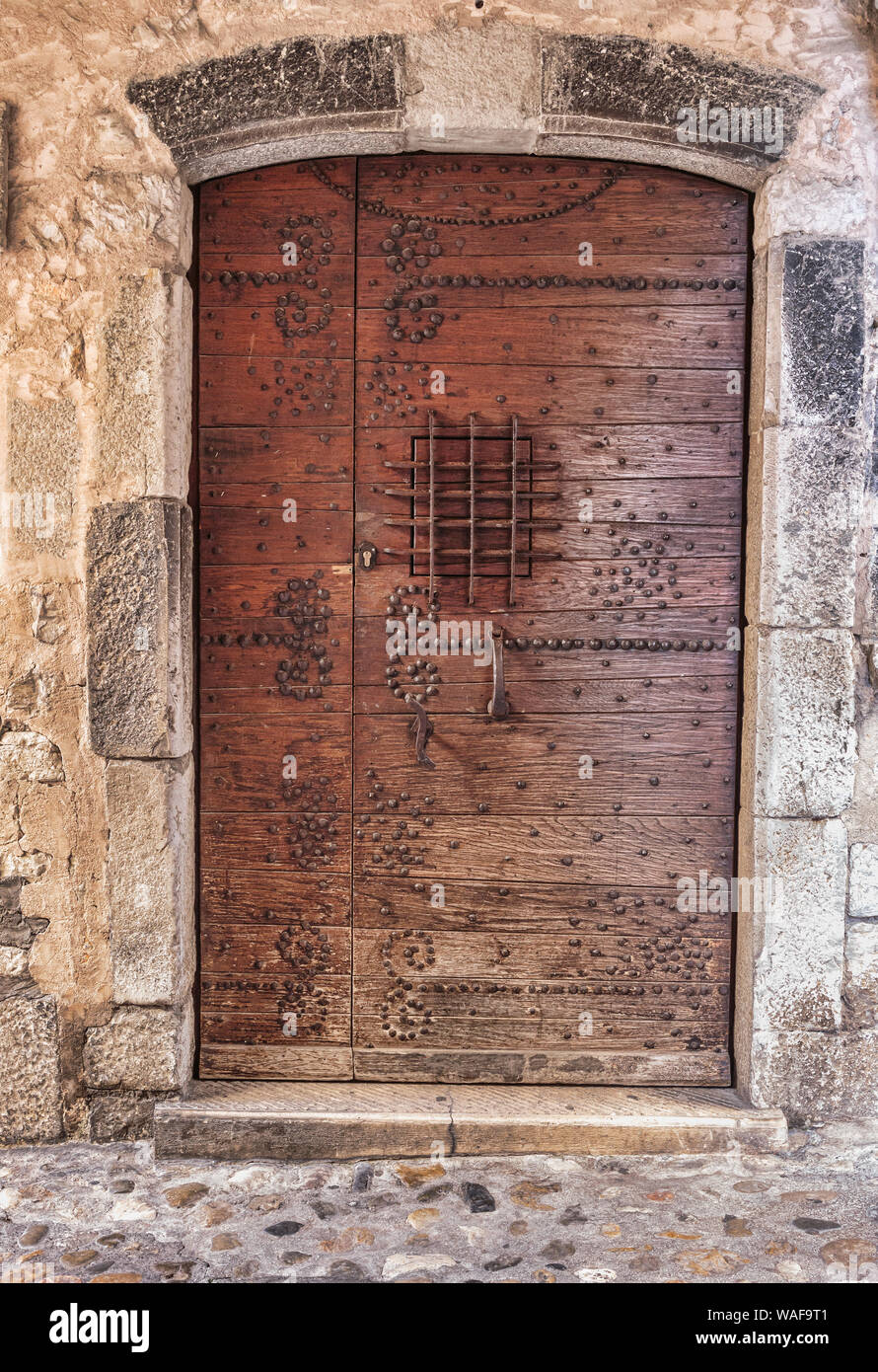 Old wooden door in the entrance stone French house Stock Photo - Alamy