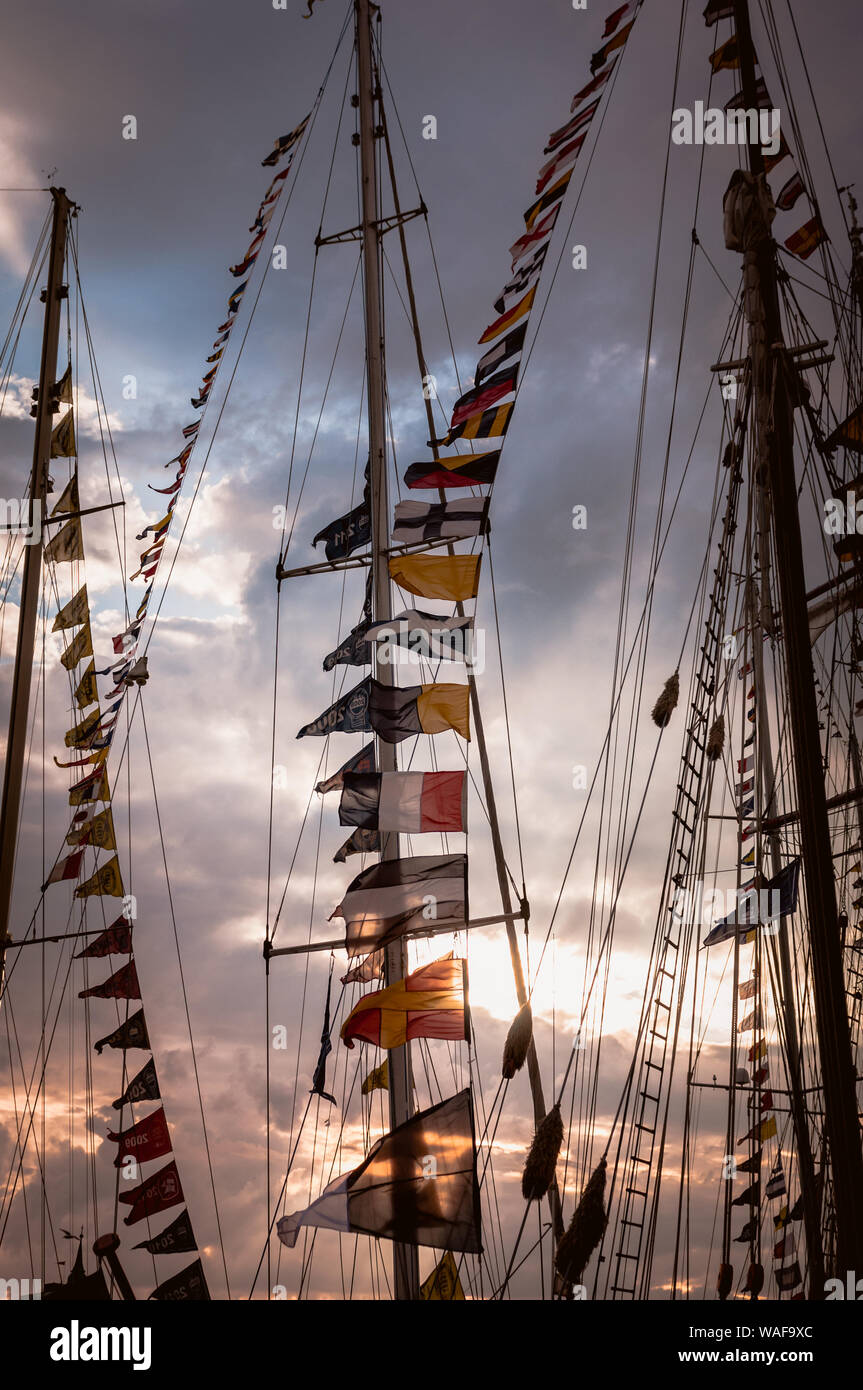 three ship masts flying flags from all over the world at the Tall Ship Races, Norway Stock Photo