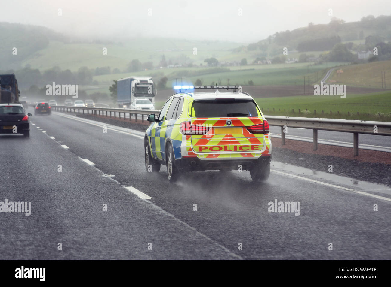 Police siren flashing blue lights driving on motorway to accident or crime scene Stock Photo