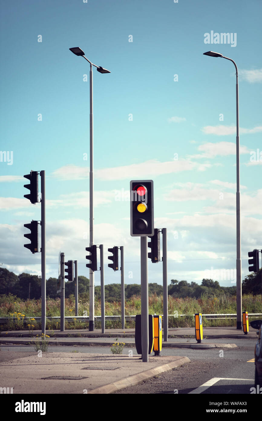 Traffic lights for cars on a road changing from red orange to green Stock Photo