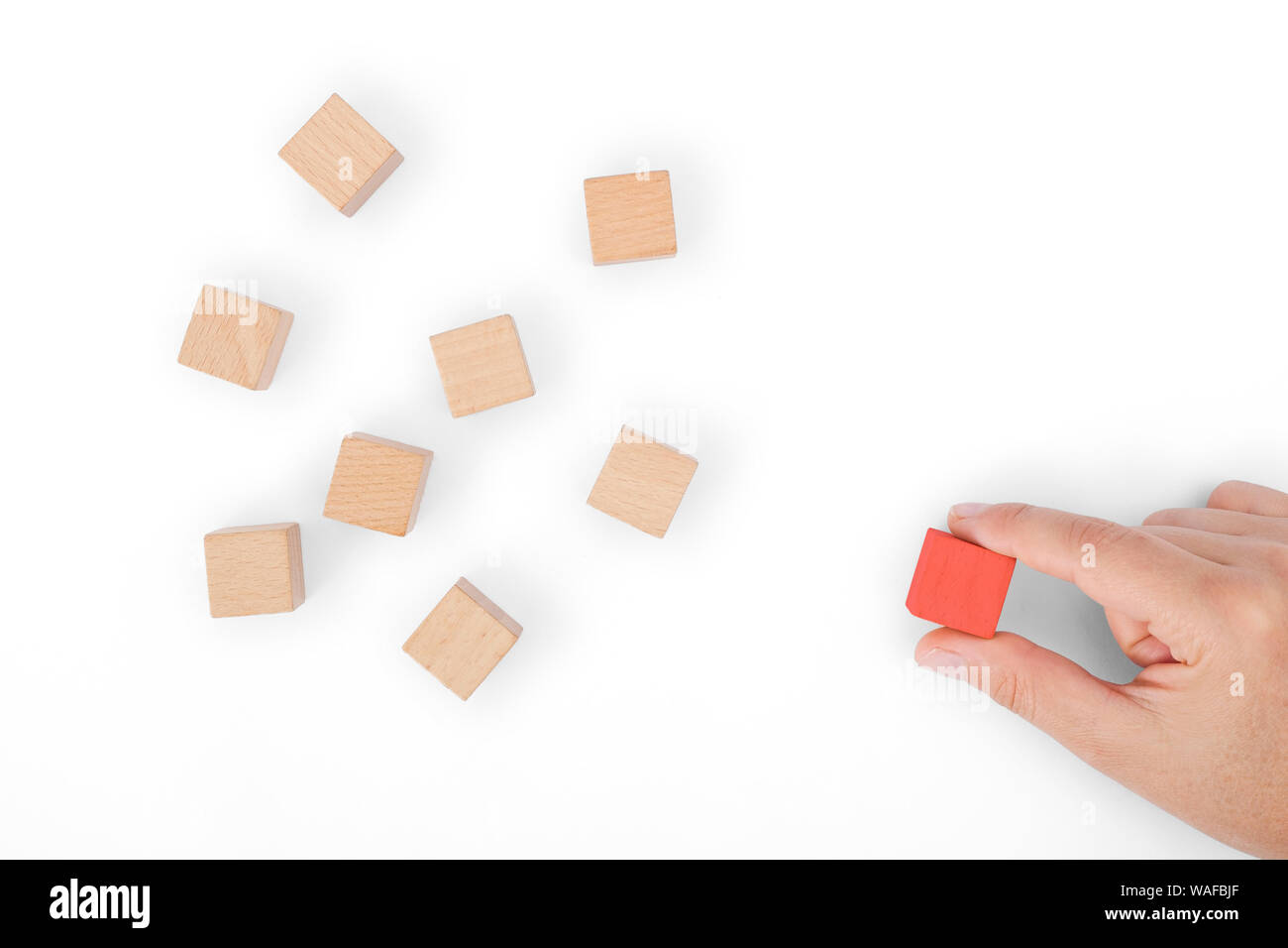 hand selects red block from block group Stock Photo - Alamy