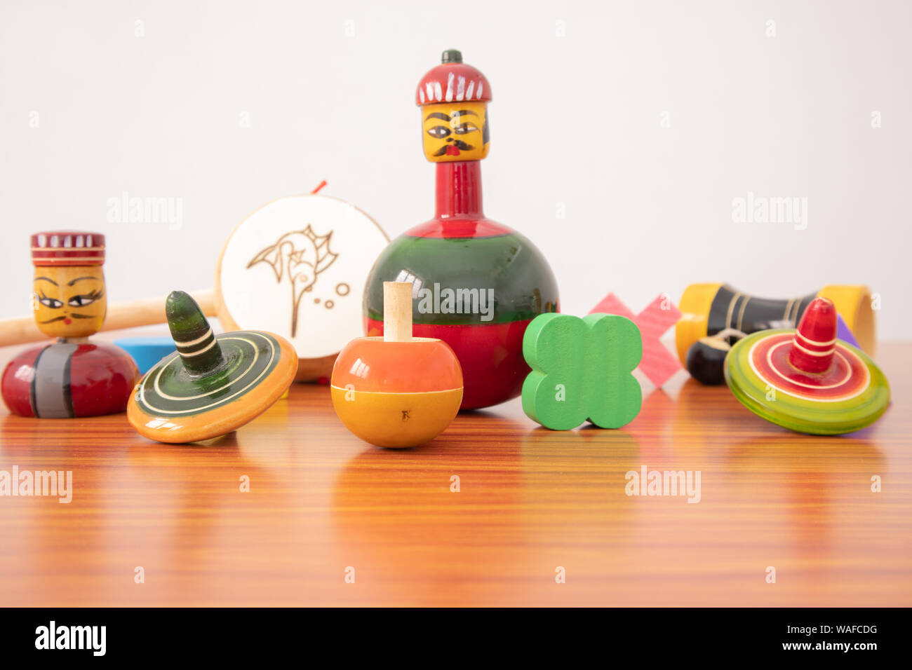 Colorful different types of GI Tagged channapatna toys on the table with isolated background Stock Photo