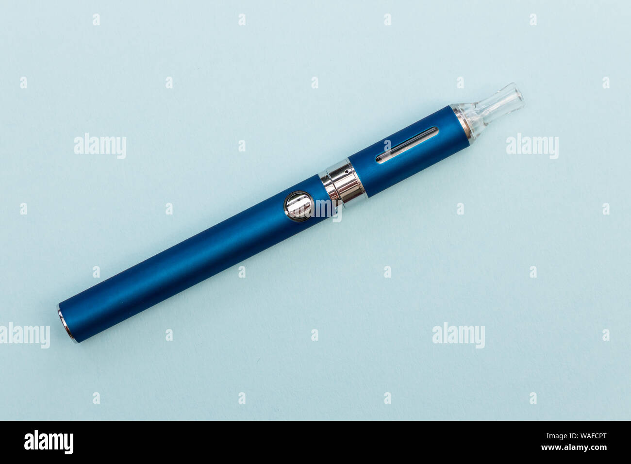 Vape pen metal electronic cigarette with vaping blue background Stock Photo
