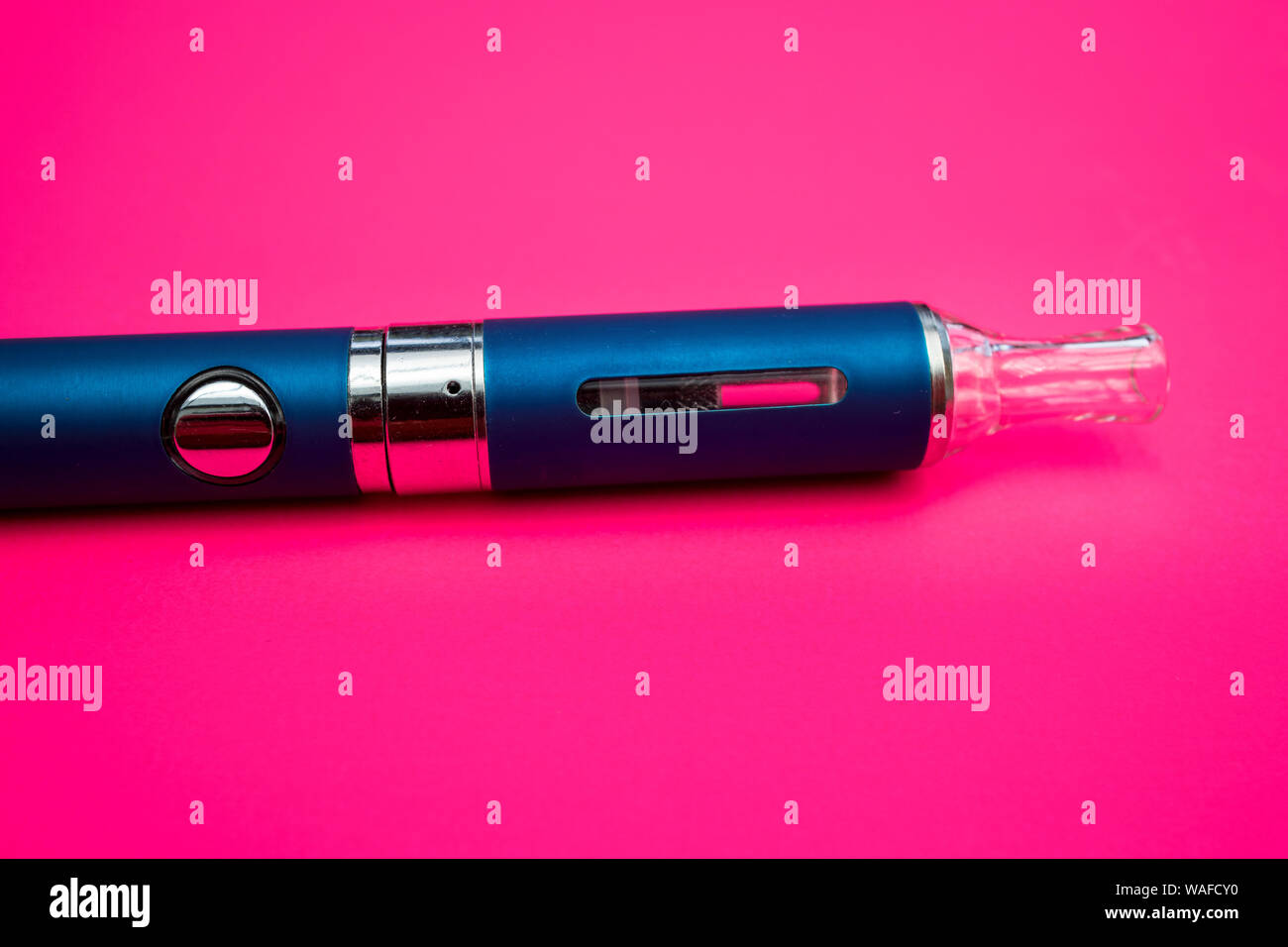 Vape pen metal electronic cigarette with vaping pink background Stock Photo