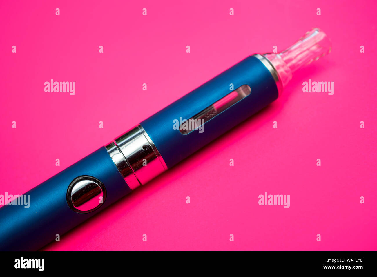 Vape pen metal electronic cigarette with vaping pink background Stock Photo