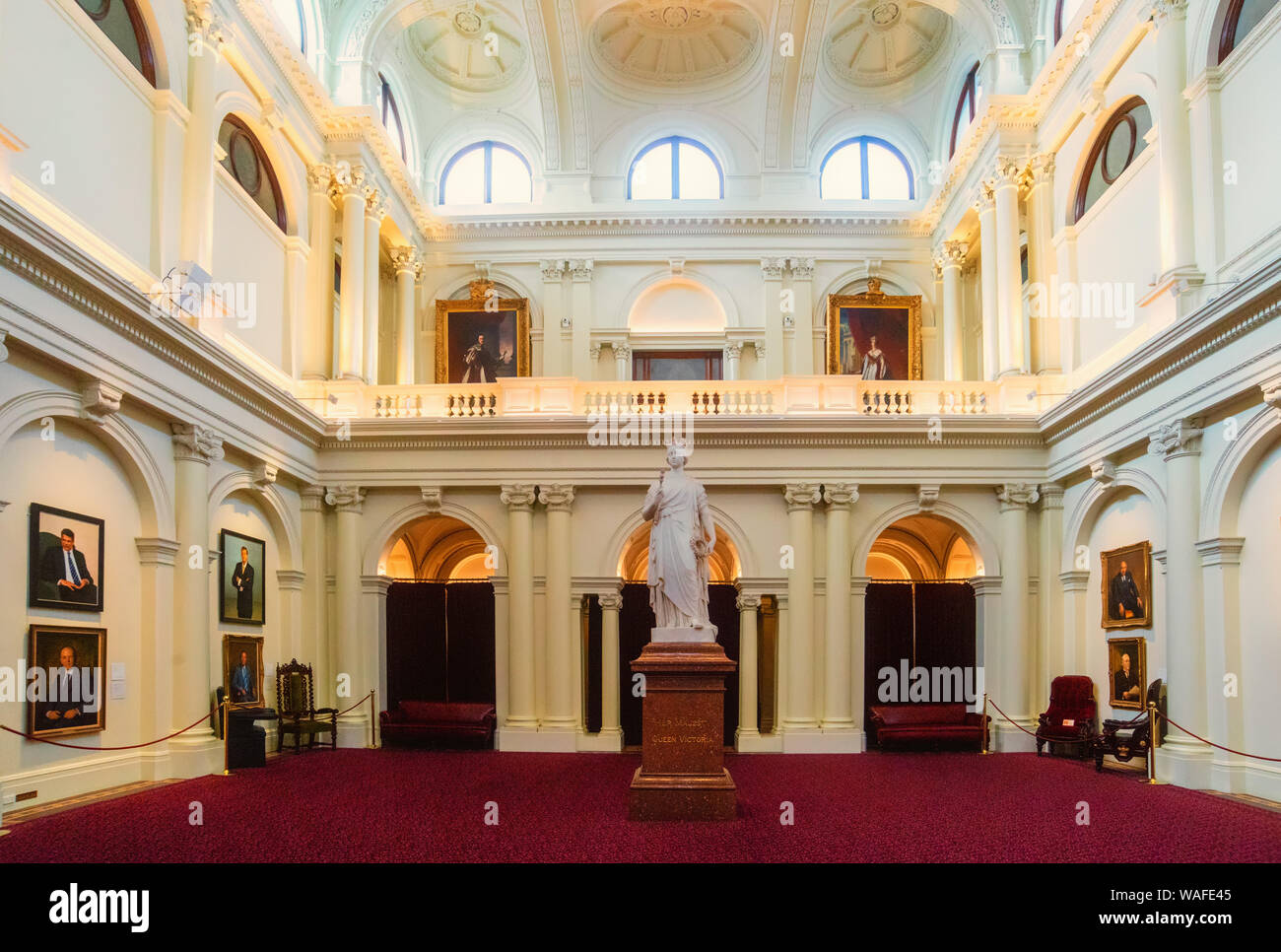 Queen's Hall in Parliament House, Melbourne, with a statue of Queen