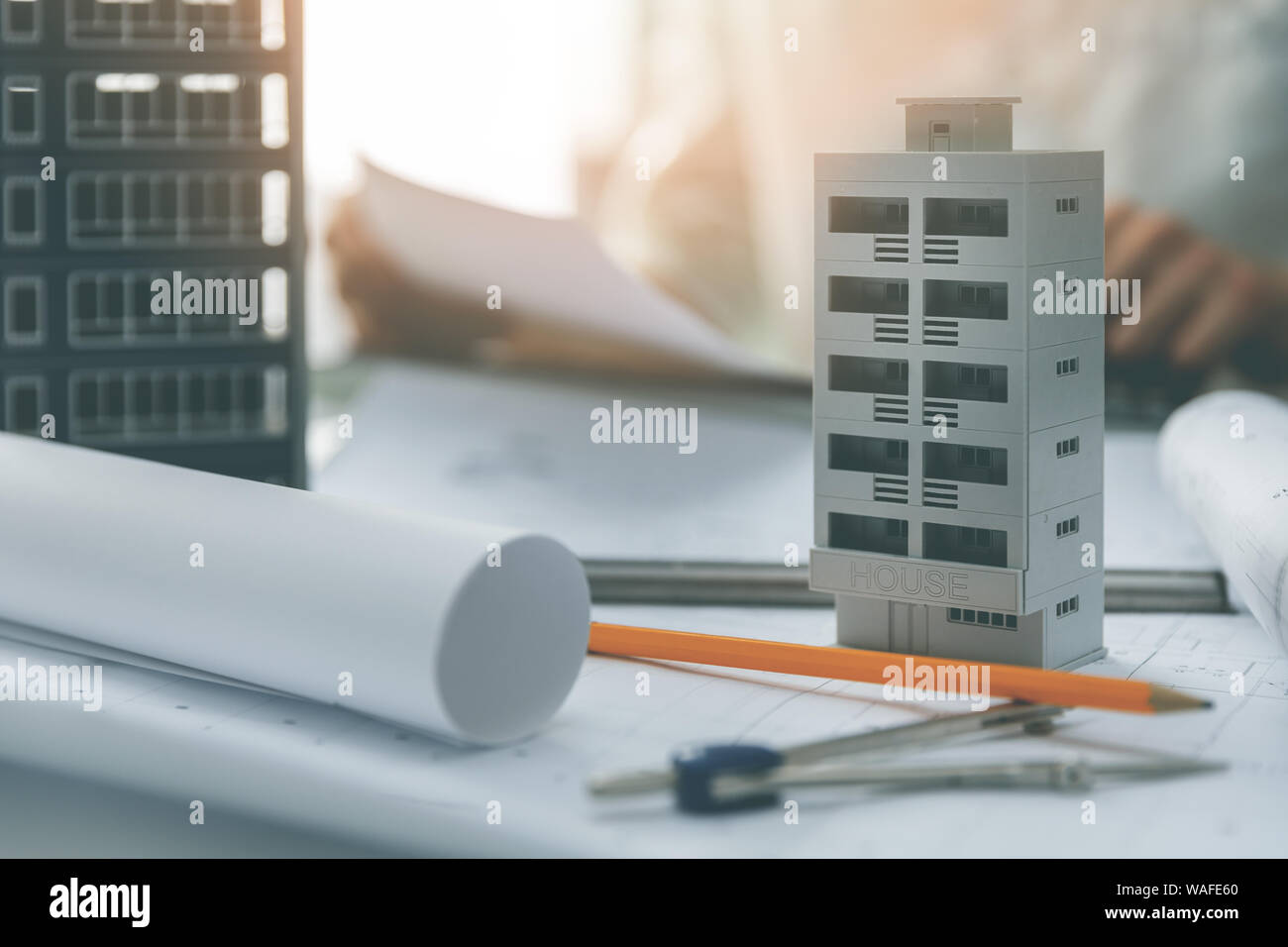 apartment building scale models and blueprints on the table in architect office Stock Photo