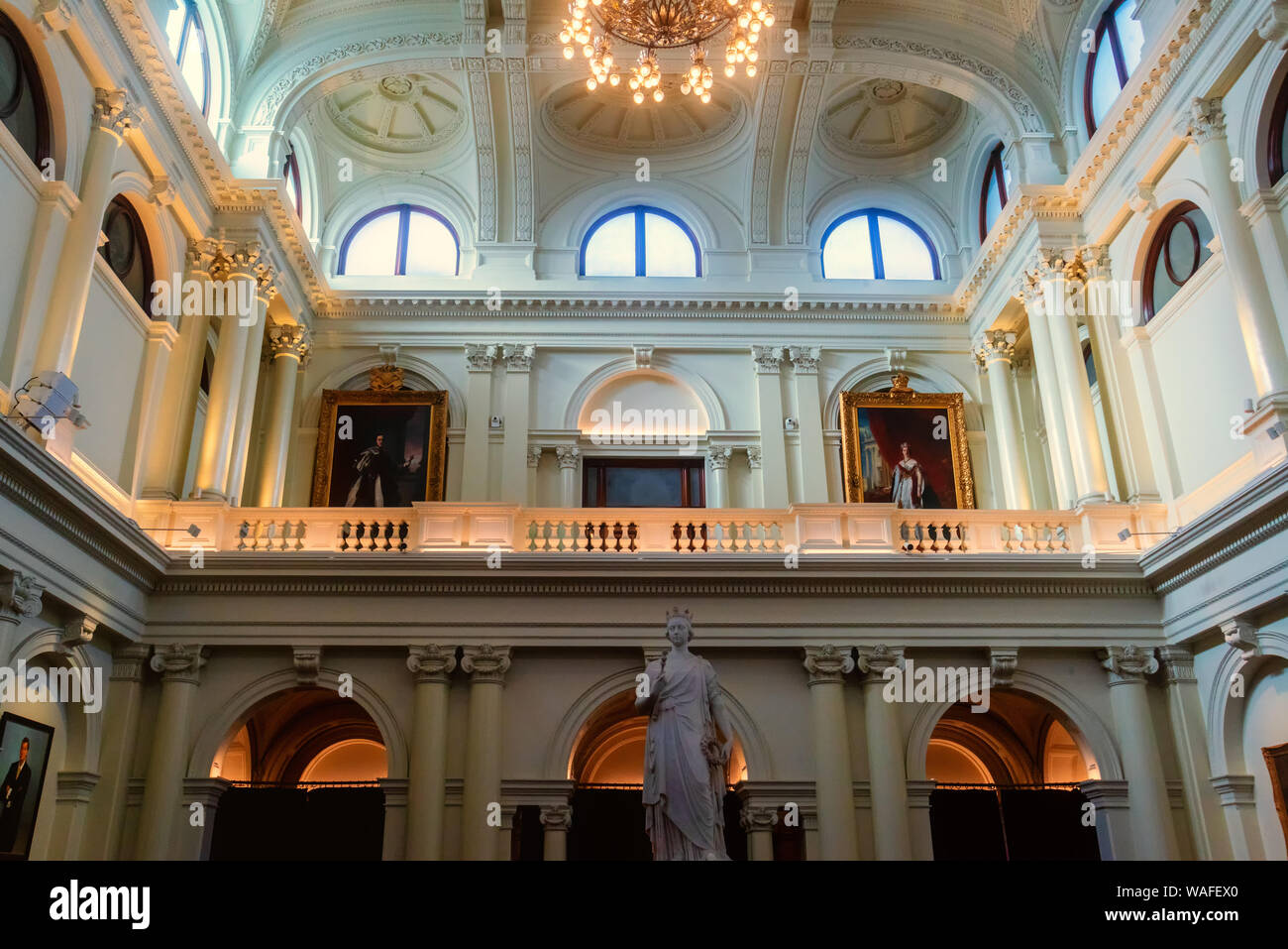 Queen's Hall in Parliament House, Melbourne, with a statue of Queen
