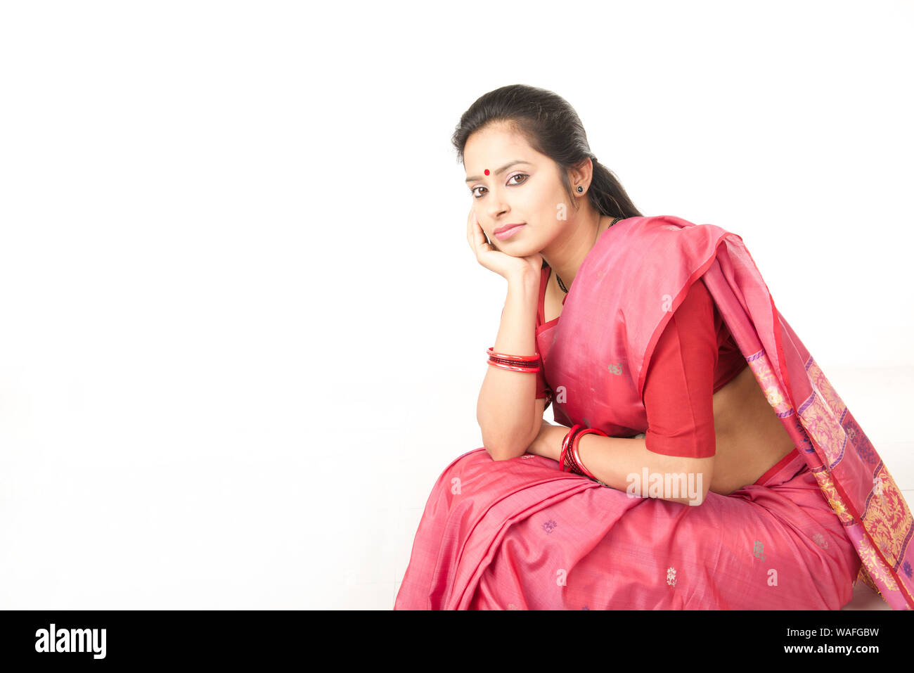 Indian young woman sitting Stock Photo - Alamy