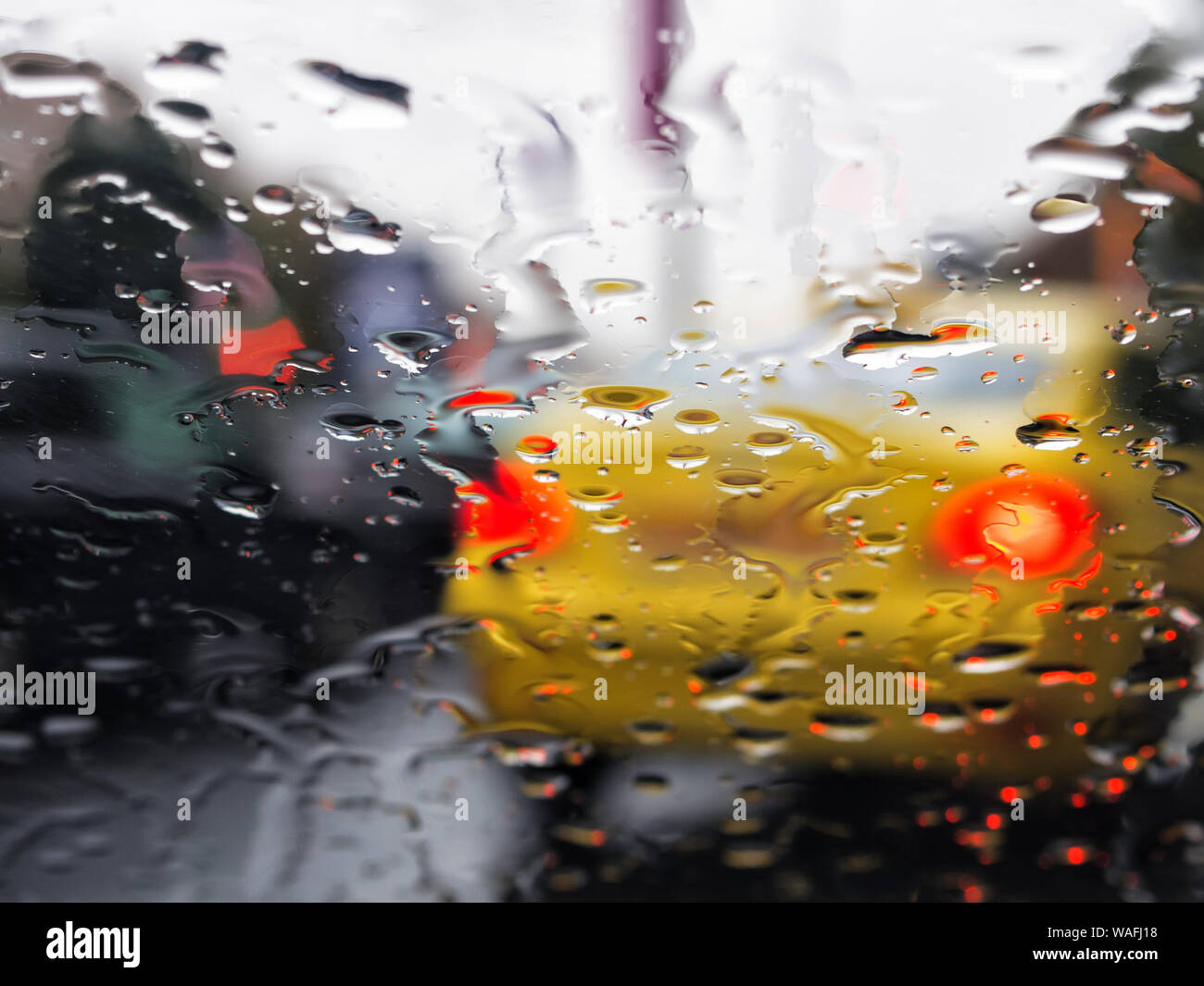 Rain on windshield of car seen from inside the car Stock Photo