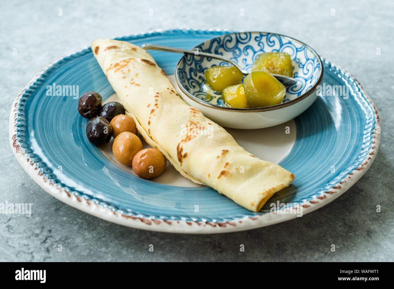 Plain Wrapped Crepe with Fig Jam, and Olives for Breakfast. Organic
