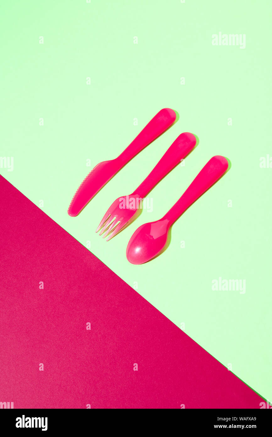 Plastic eating utensil set from fork, knife and spoon on a duotone