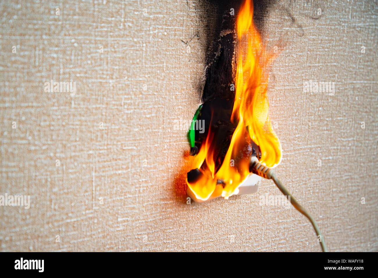 Burning electrical wiring and electrical outlet. Faulty wiring causes