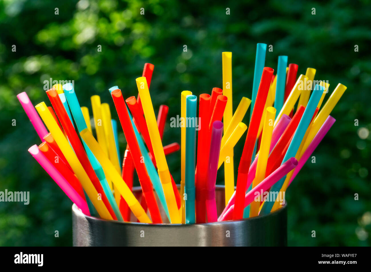 Many different coloured straws against a dark background Stock Photo