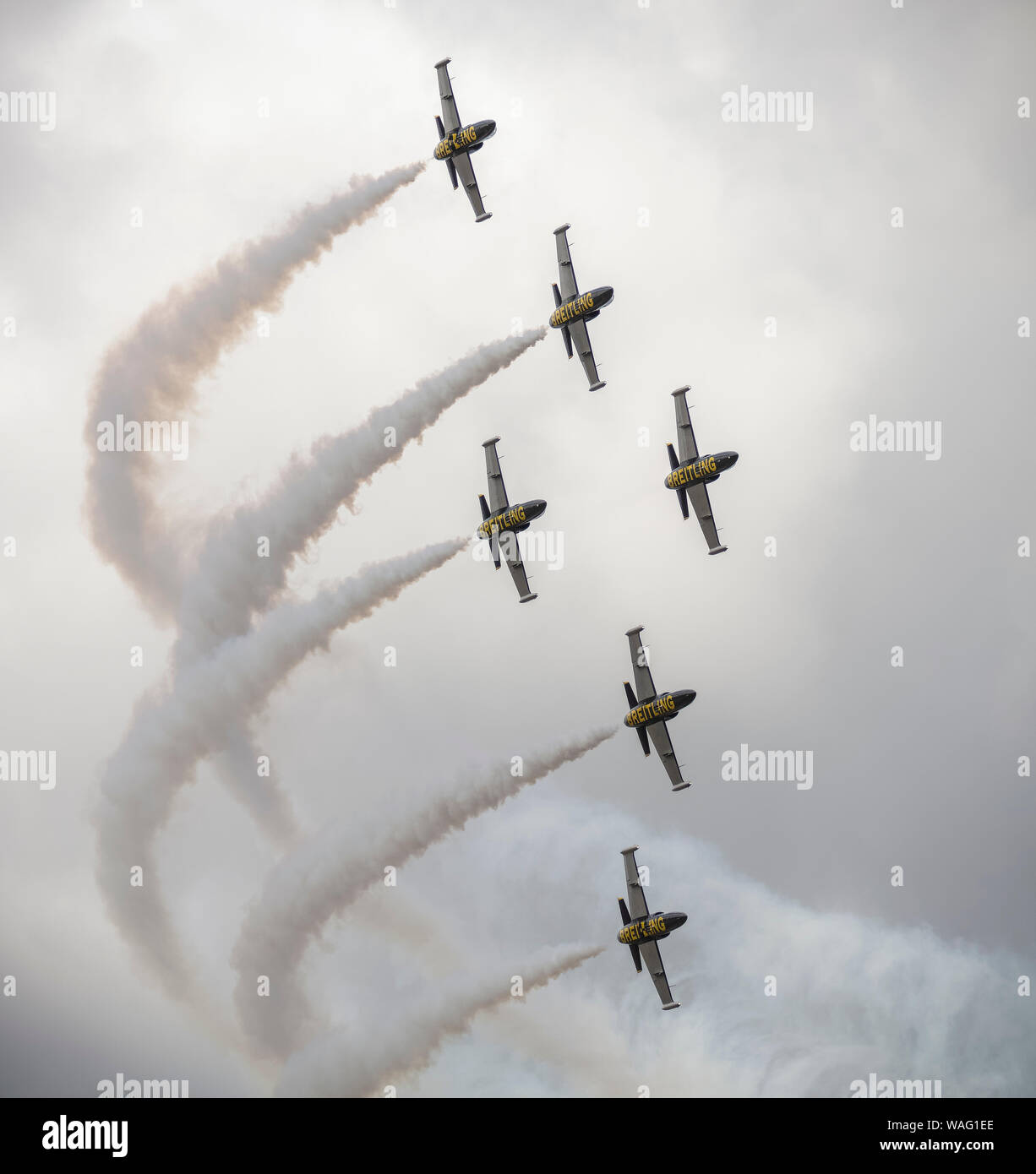 Six Breiling L-39 Albatros jets forming part of the Breitling Aerobatic Jet Team in the sky with white smoke trails forming a manoeuvre Stock Photo