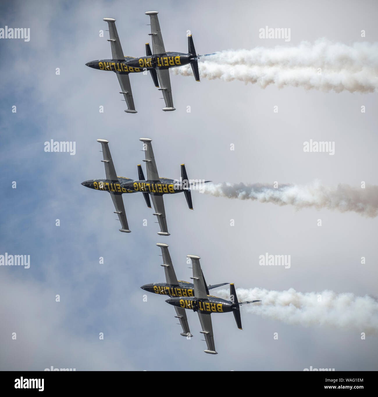 Six L-39 Albatros jet planes forming part of the Breitling Jet Aerobatic Team in the sky with white smoke trails Stock Photo