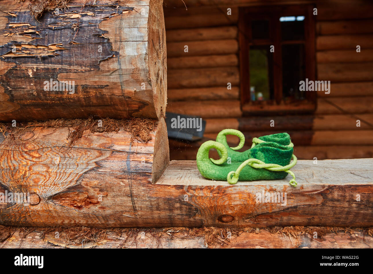 Elf shoes in the window opening of an old wooden house Stock Photo Alamy