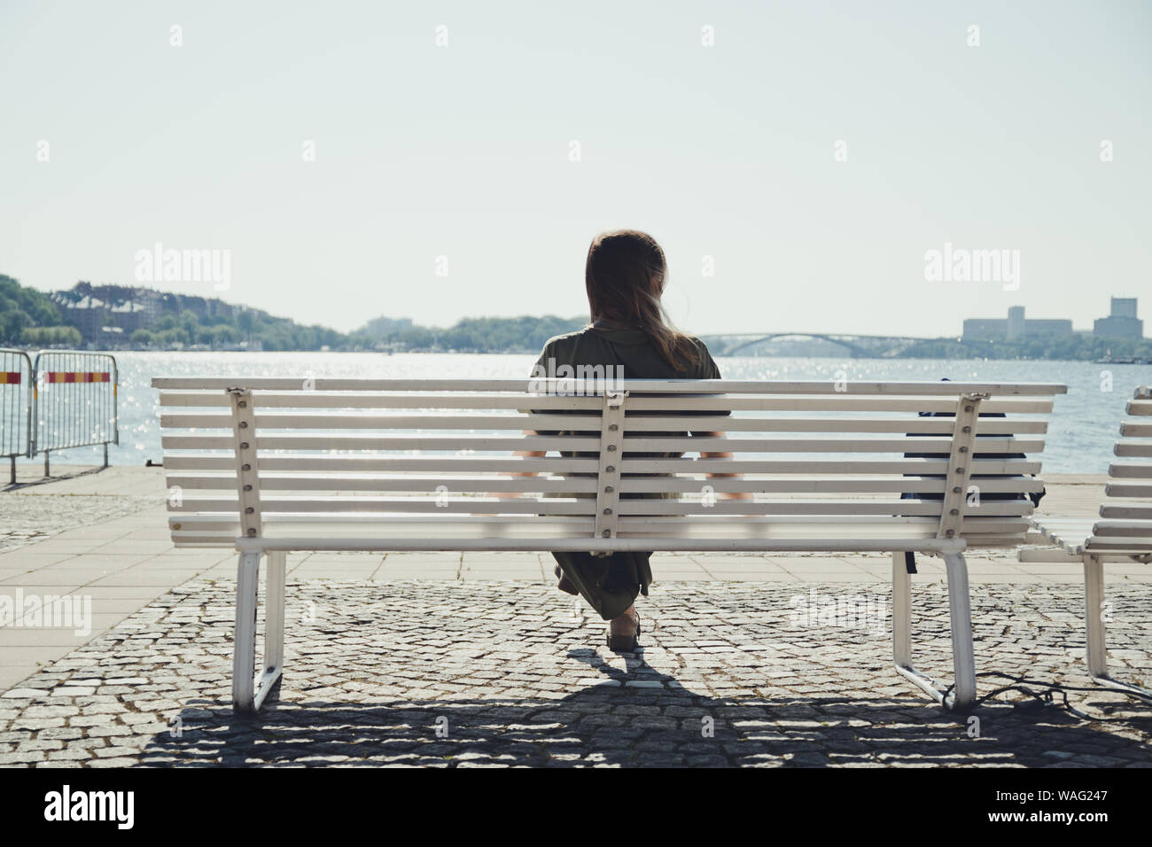 Sad girl sitting on bench hi-res stock photography and images - Alamy