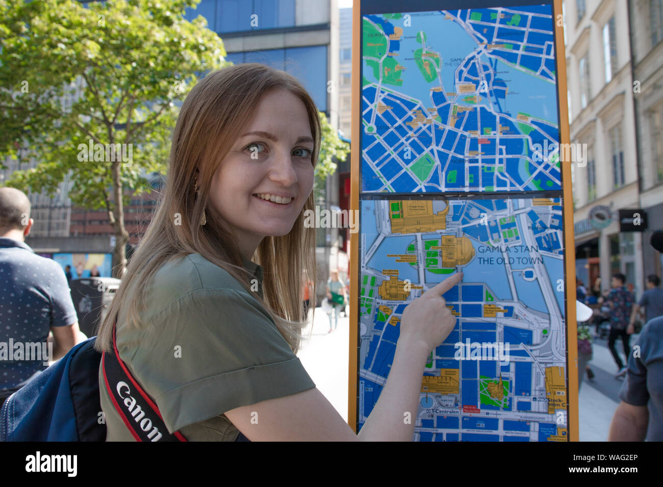 Stockholm, Sweden June 7 2019: Young blonde girl shows a finger at a map. Travel  Route Finder Stock Photo - Alamy