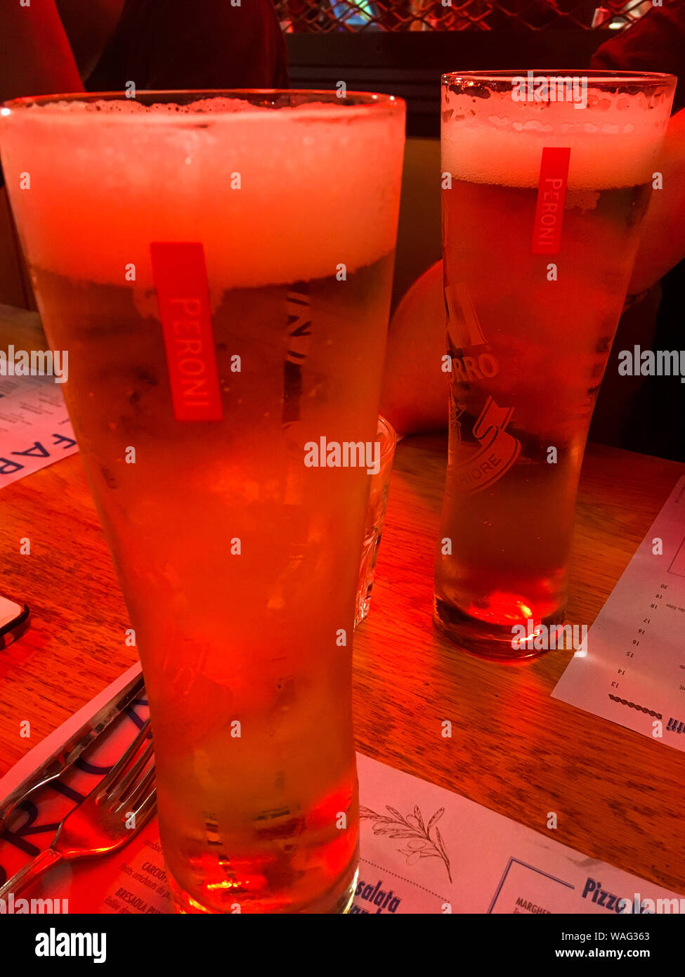 https://c8.alamy.com/comp/WAG363/glasses-of-peroni-beer-putted-on-a-table-in-a-red-lighted-bar-paris-ile-de-france-france-WAG363.jpg