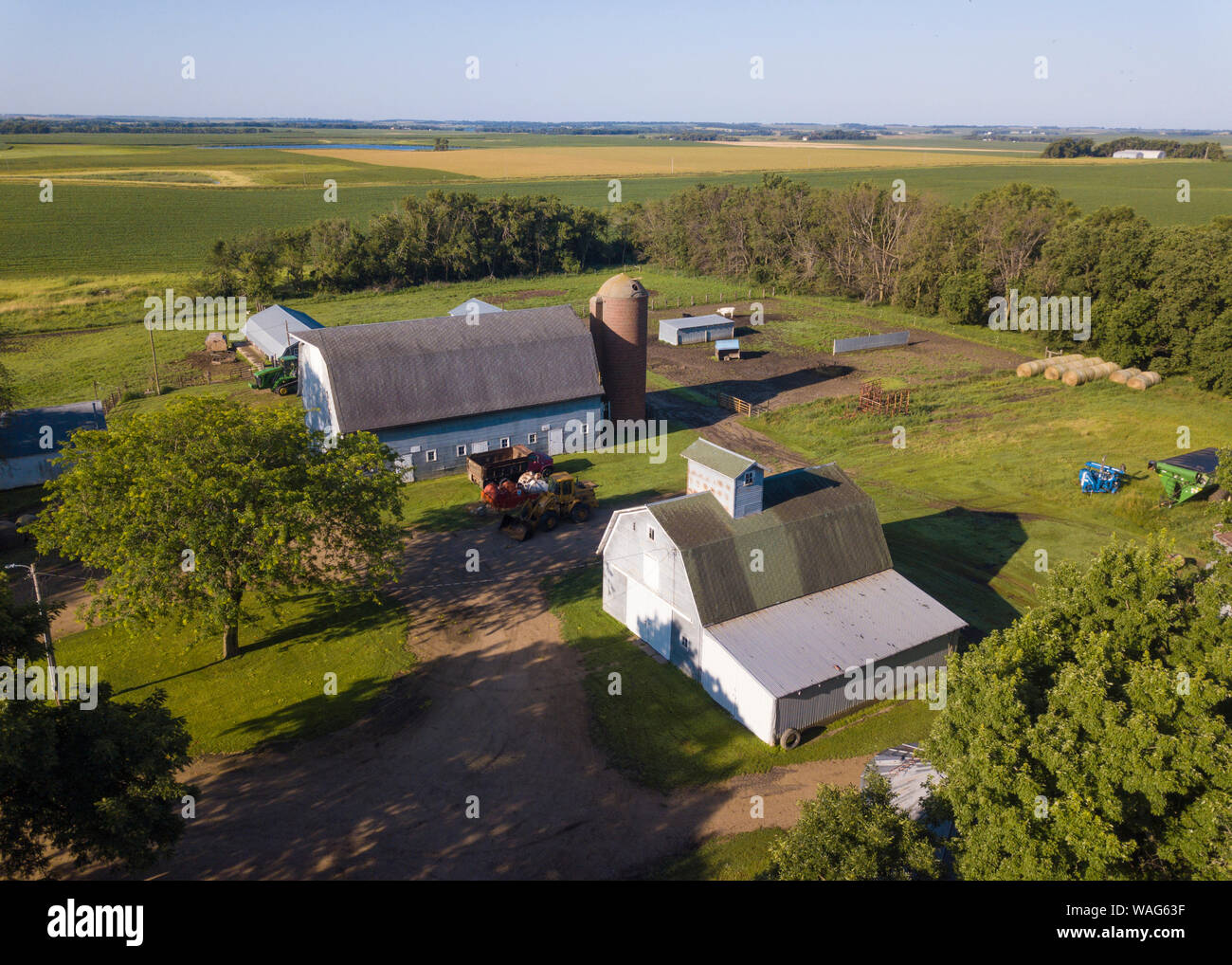 Aerial view of property released farm buildings in South Dakota with fields in the background. Stock Photo