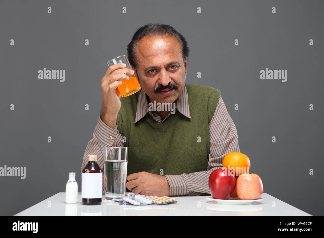 Senior man drinking orange juice hires stock photography and images