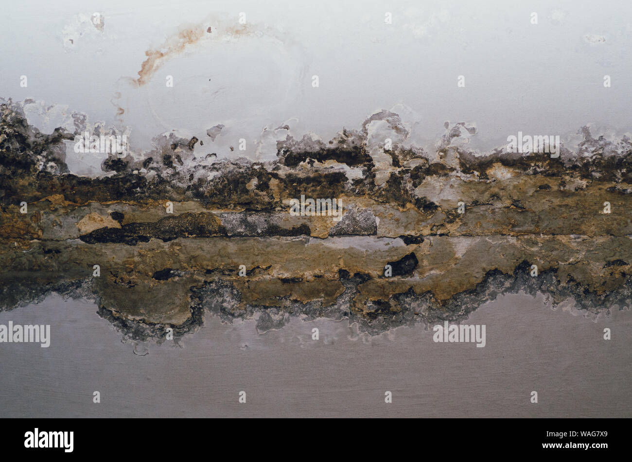 Big wet spots and cracks on the ceiling of the domestic house room
