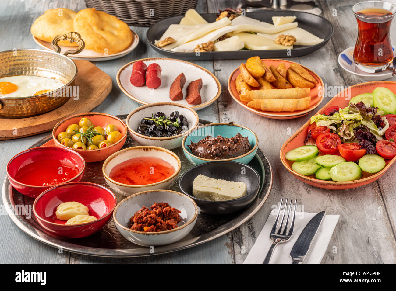 Traditional Turkish Breakfast served with traditional turkish tea on wooden table Stock Photo