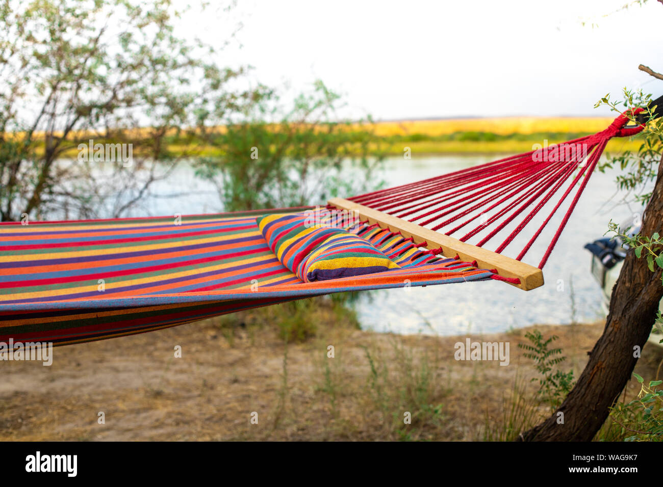 Hammock on the background of the river. Camping in the wild. A weekend away from civilization. Tourism in Kazakhstan. Conditions for complete relaxati Stock Photo