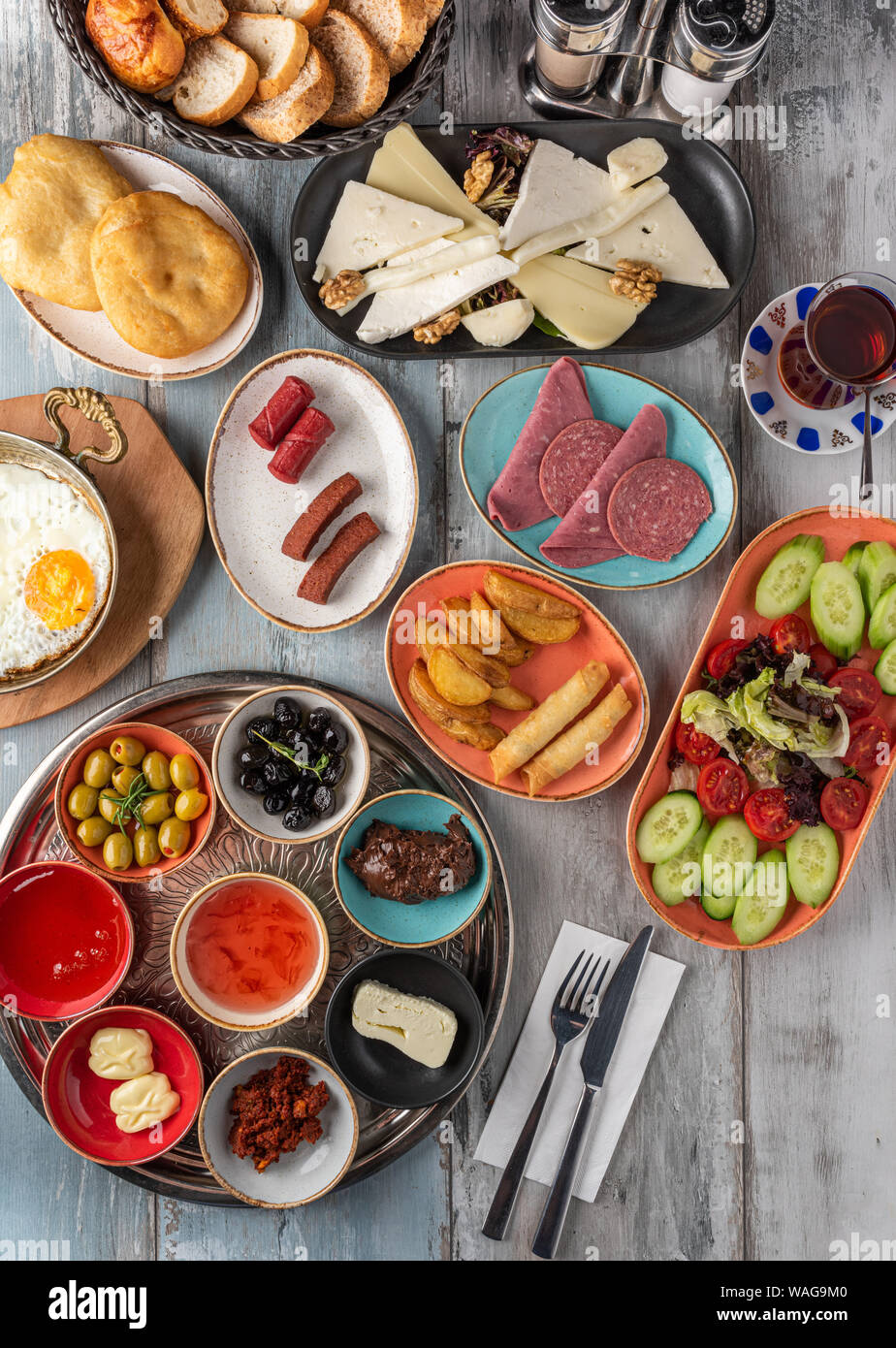 Traditional Turkish Breakfast served with traditional turkish tea on wooden table Stock Photo