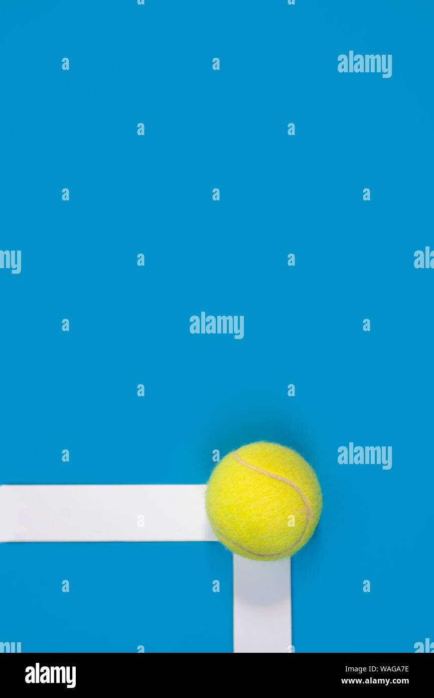 Big tennis ball on blue background In or out challenge hard court Stock Photo