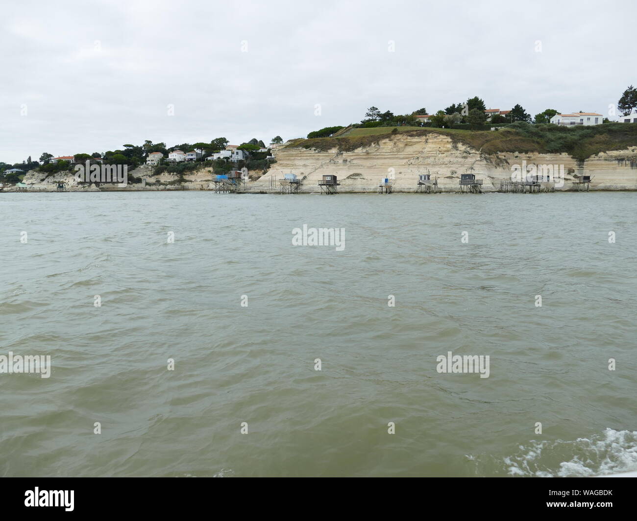 Crutse in the Gironde estuary to see the troglodyte caves in the cliffs of Meschers Stock Photo