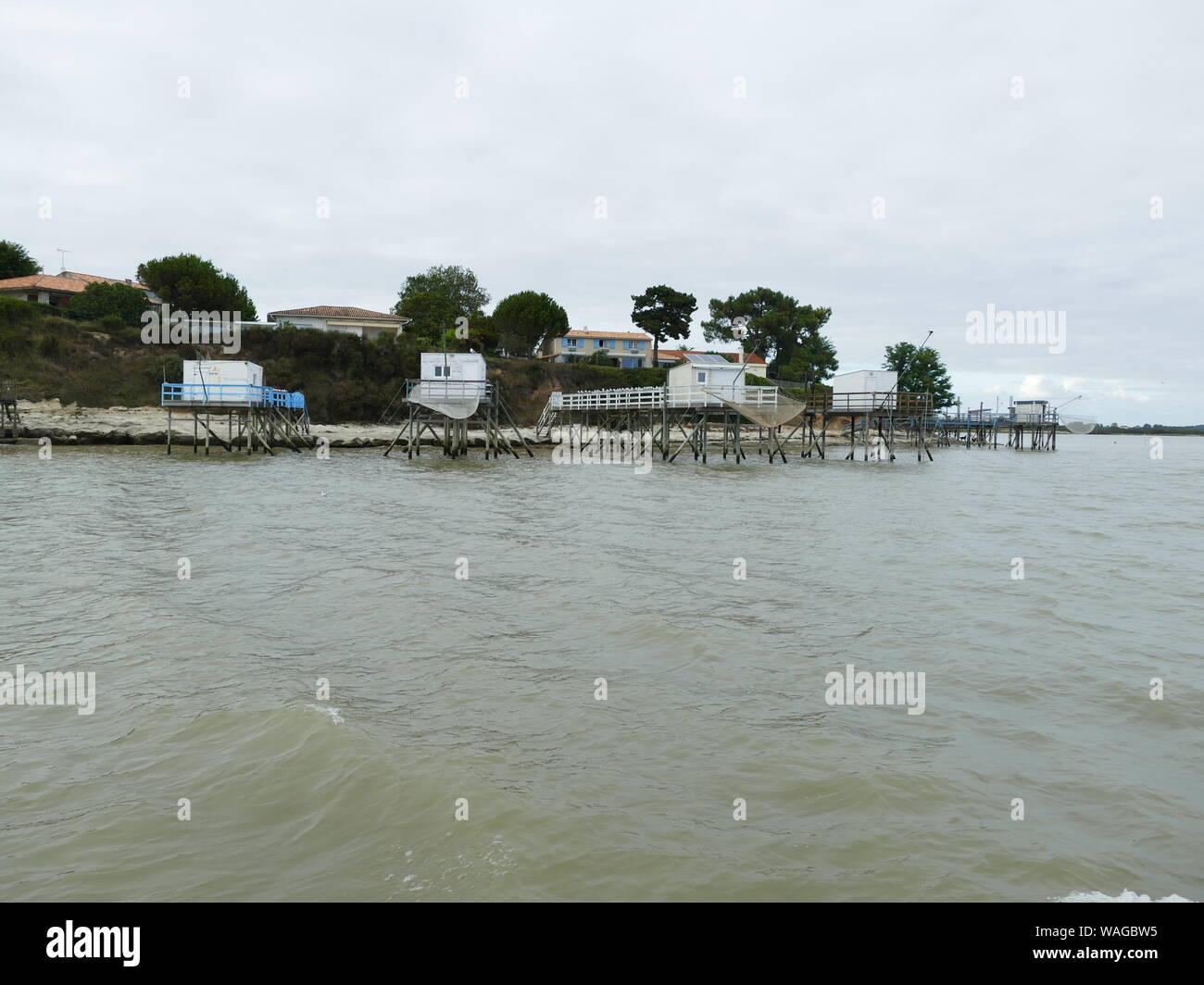 Crutse in the Gironde estuary to see the troglodyte caves in the cliffs of Meschers Stock Photo