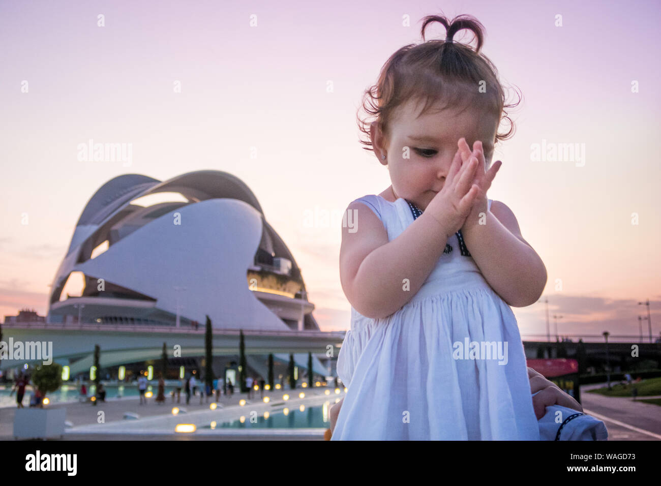 A little baby playing and smiling in Valencia park Stock Photo