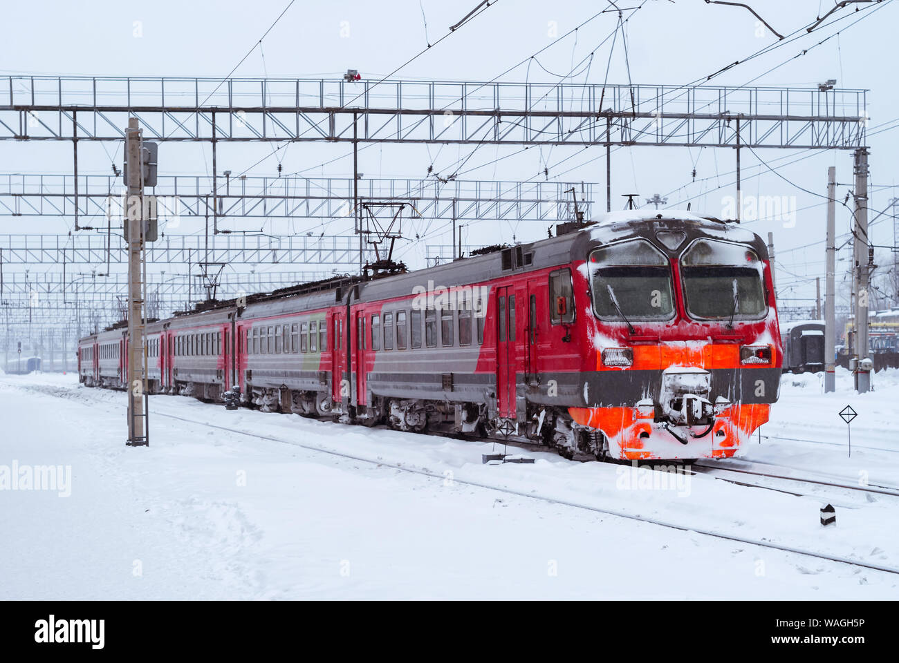 ice-covered electric multiple unit train at a railway junction in winter Stock Photo