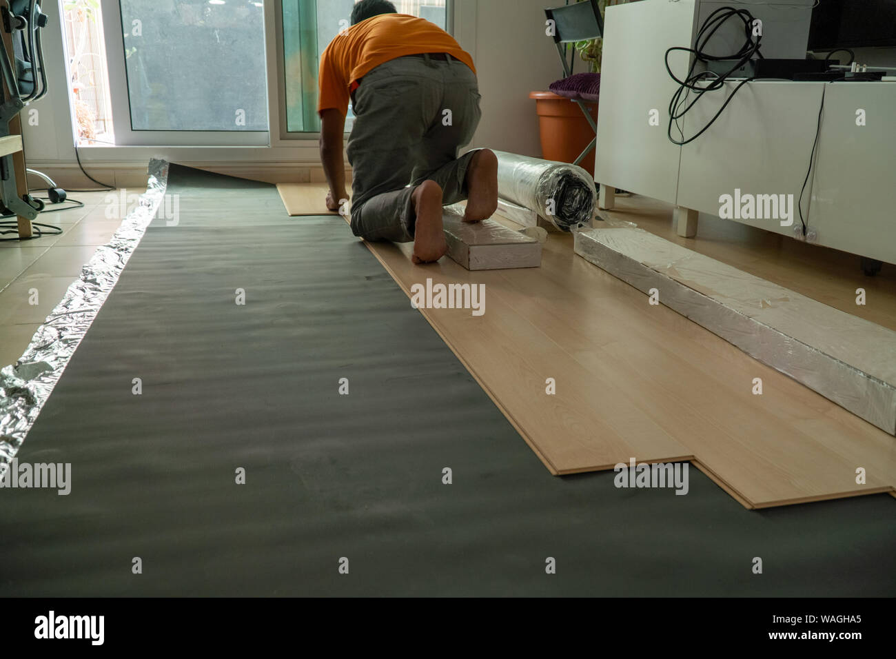 Professional Worker Installing Laminated Parquet Floor In To A