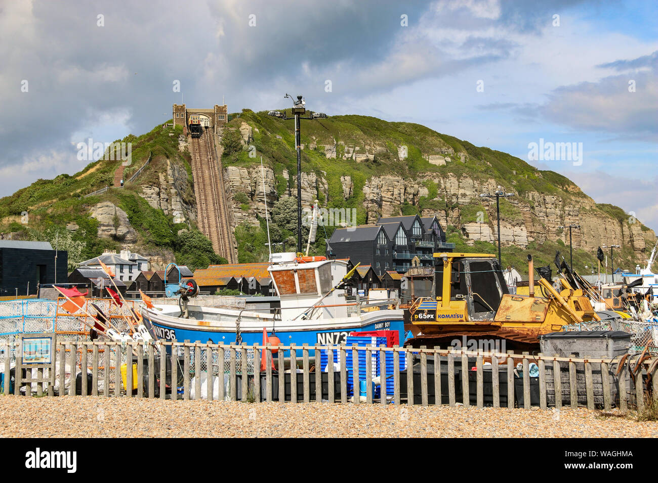 Fishing boats with paraphenalia on the shingle beach of the Old Town, with the steep funicular railway int he background, Hastings, East Sussex, UK Stock Photo