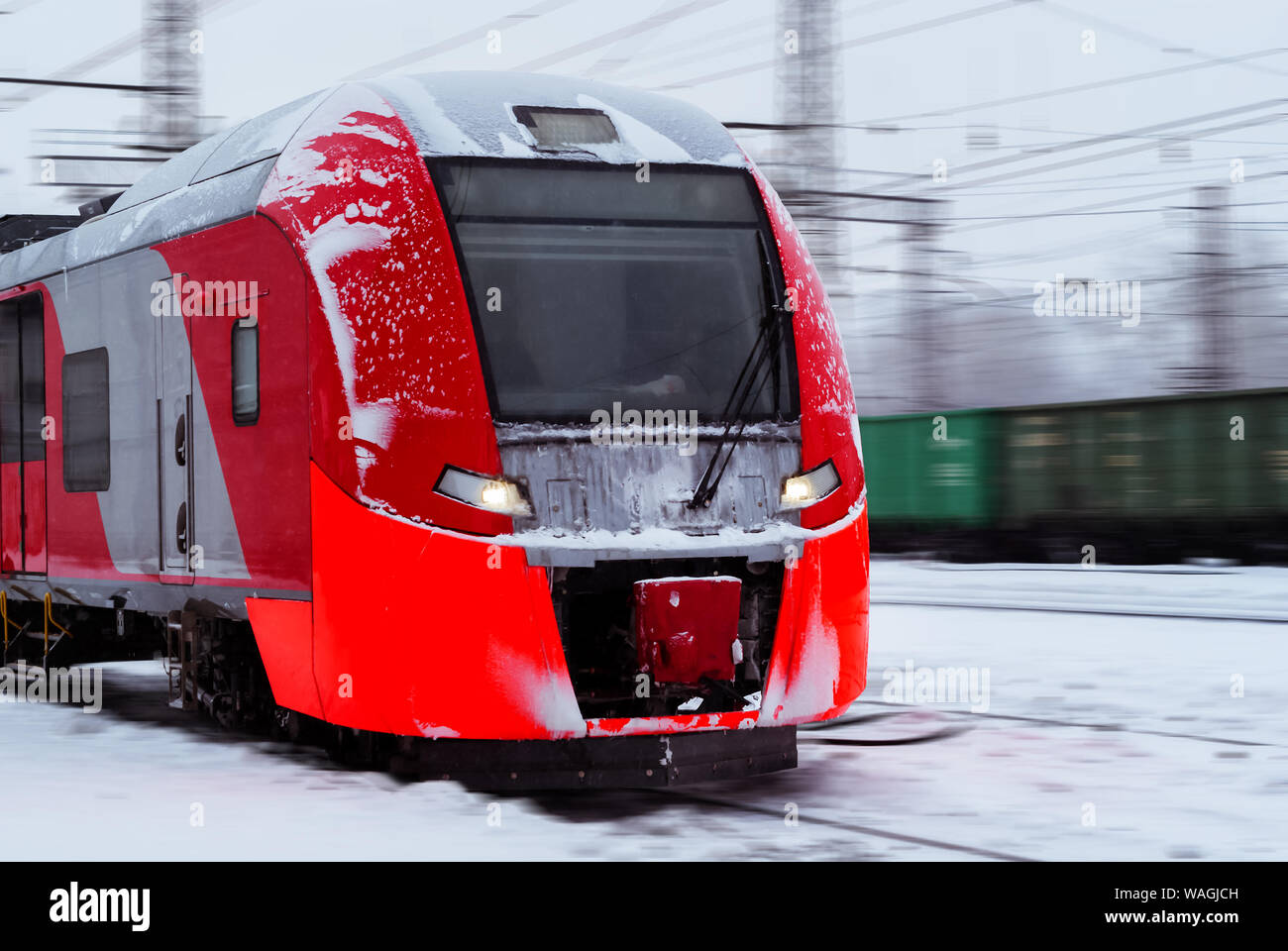 Train Light Iced ice-covered electric multiple unit train rushes along a blurred winter ...