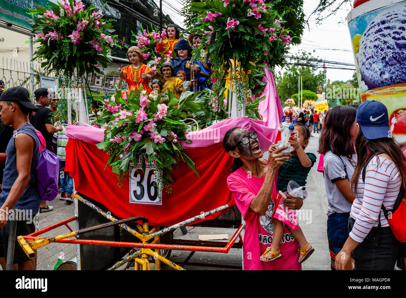 A Procession Of Floats With Santo Nino Statues Take Part In A Street
