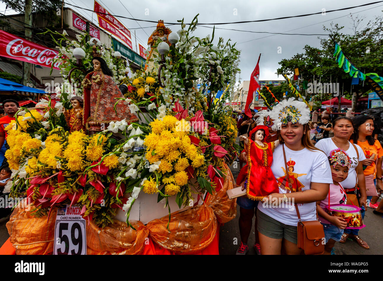 A Procession Of Floats With Santo Nino Statues Take Part In A Street