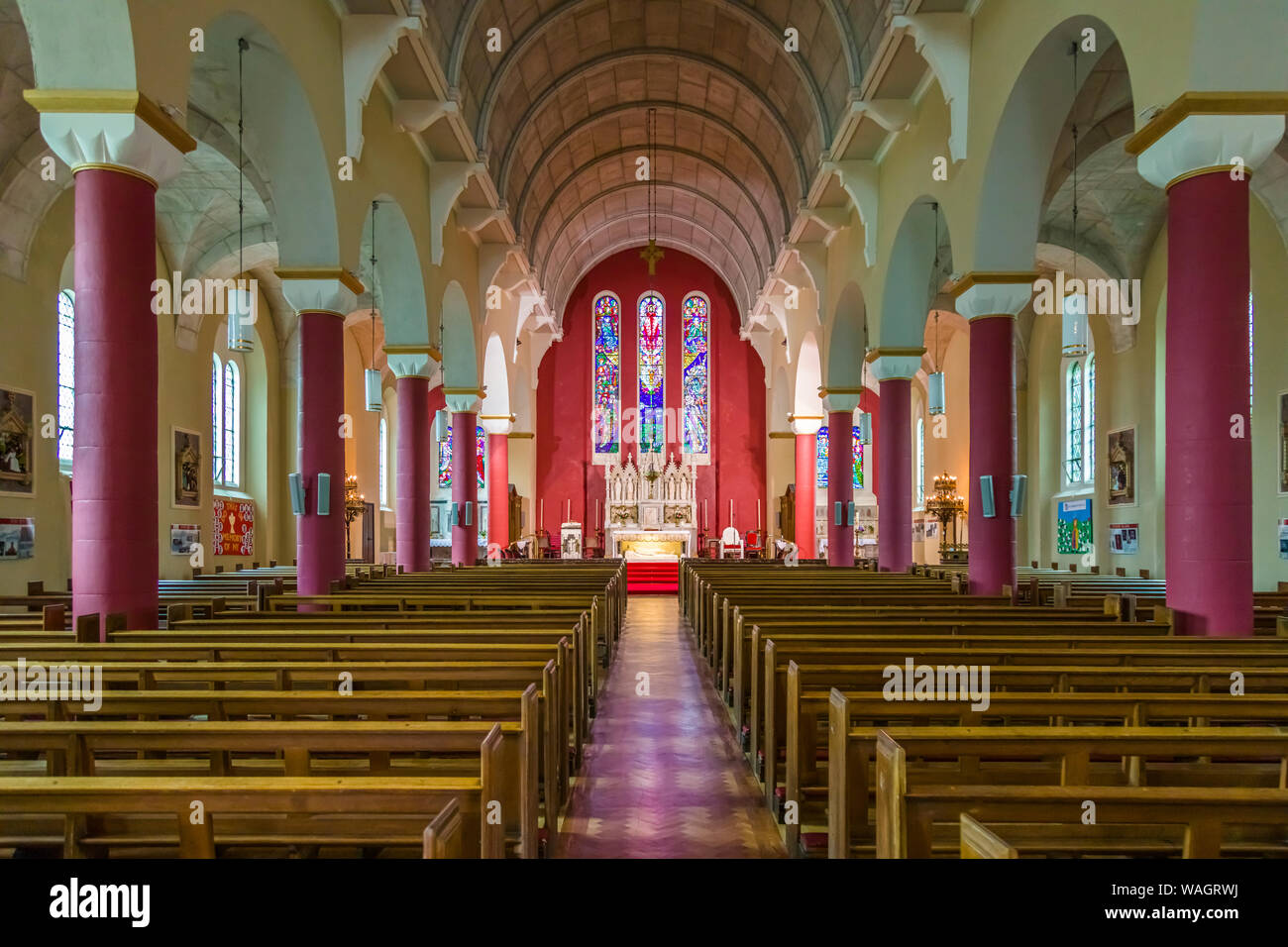 Interior of St Patricks Catholic Church with 3 bay stained glass window by Ireland's most famous stained glass artist, Harry Clarke' 1889-1931 .in New Stock Photo