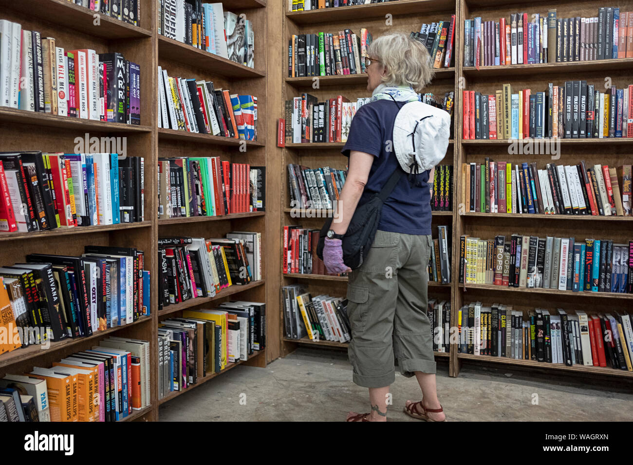 A woman shopping for music books at The Strand Book Store on Broadway in Greenwich Village, New York City. Stock Photo
