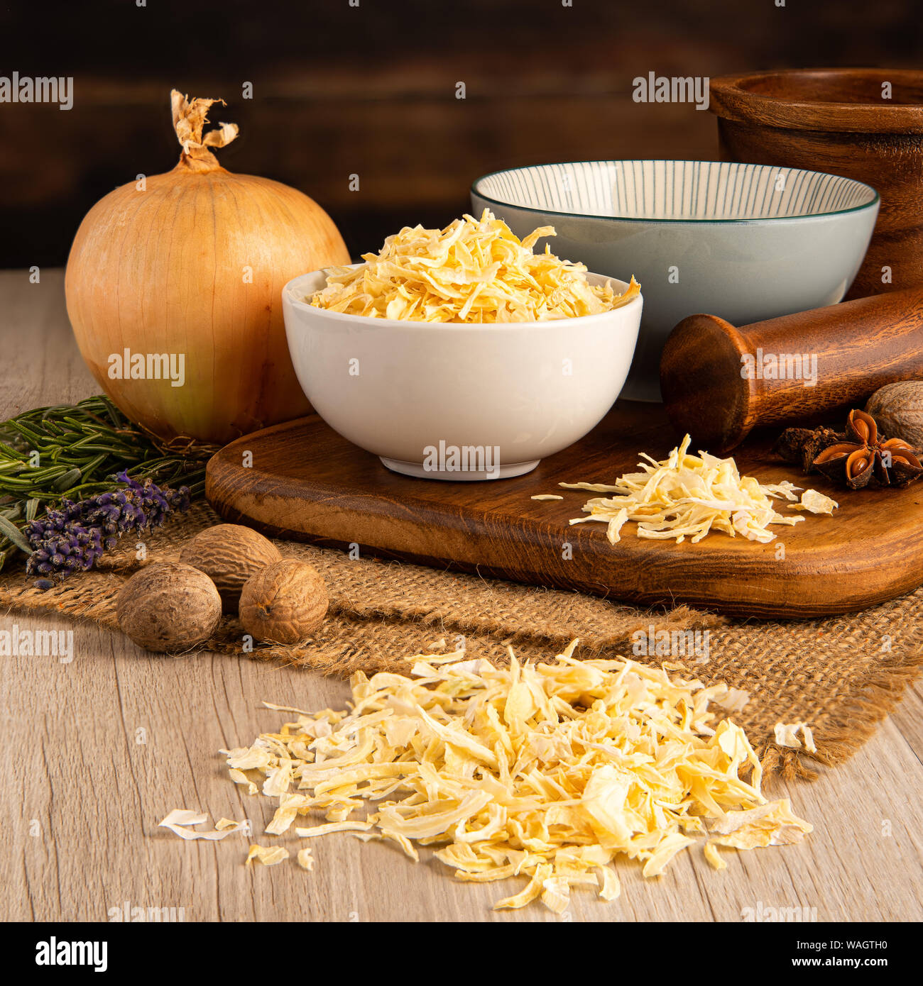 Dry Kibbled Onions in a bowl and food preparation and kitchen setting Stock Photo