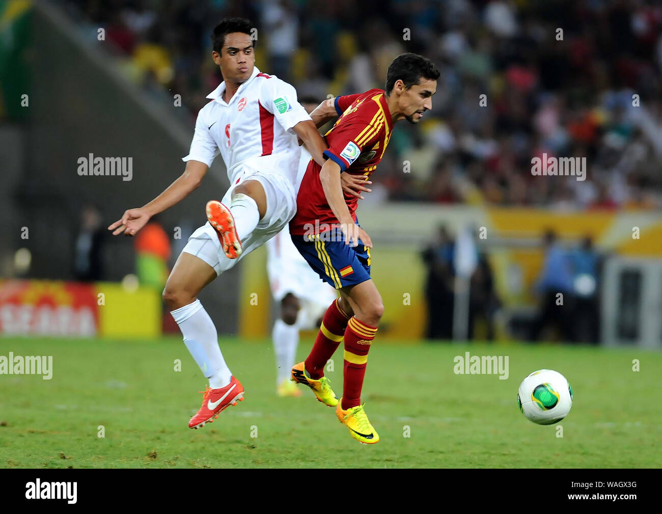 Rio de Janeiro, Brazil, June 20, 2013. Soccer players compete for the ball during the match Spain vs Tahiti for the 2013 Confederations Cup at the Mar Stock Photo
