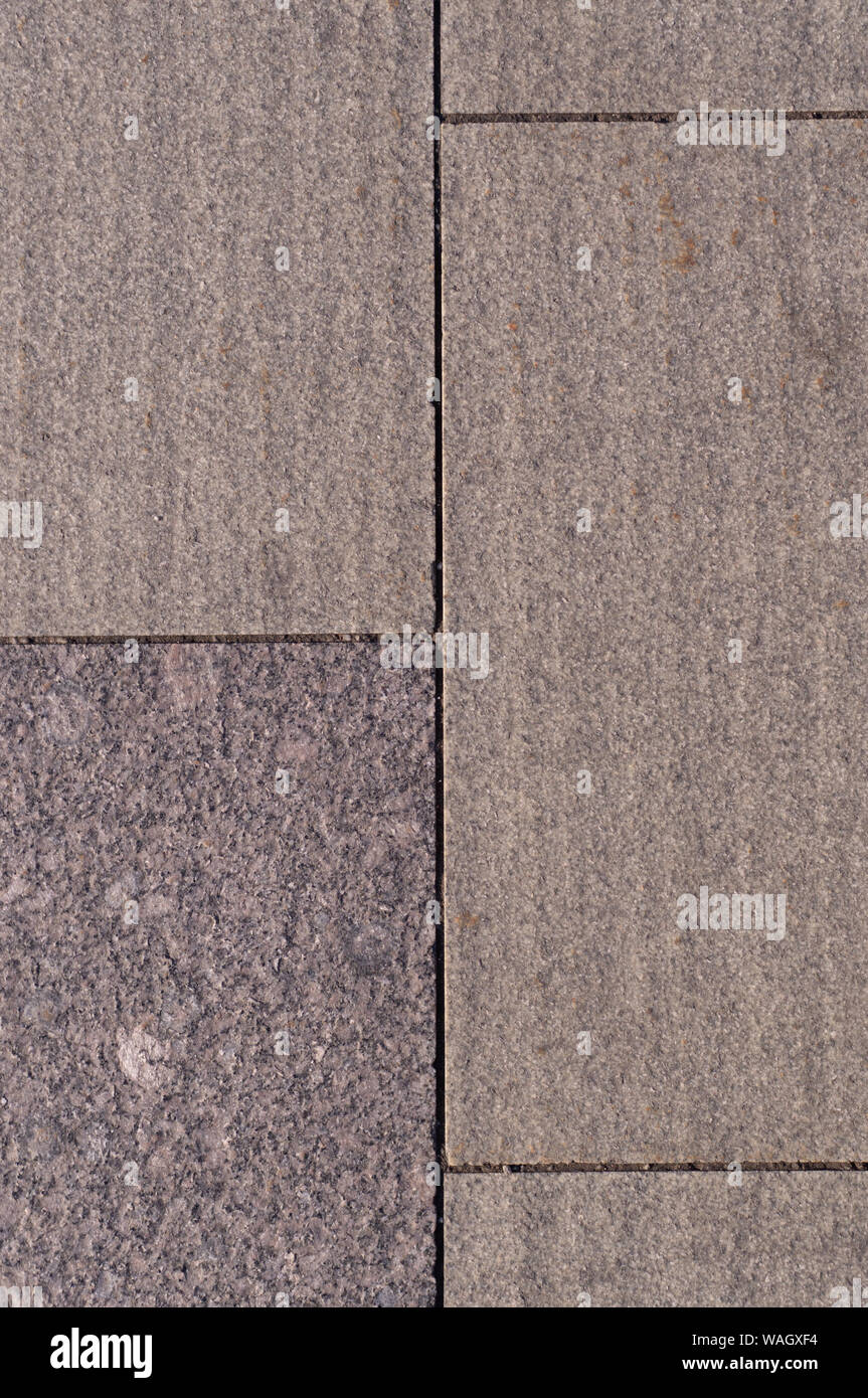 beige weathered granite stone tiled wall background. texture. Stock Photo