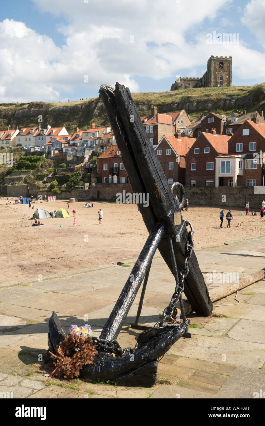 An old anchor with a wooden stock on Tate Hill pier with St Mary's