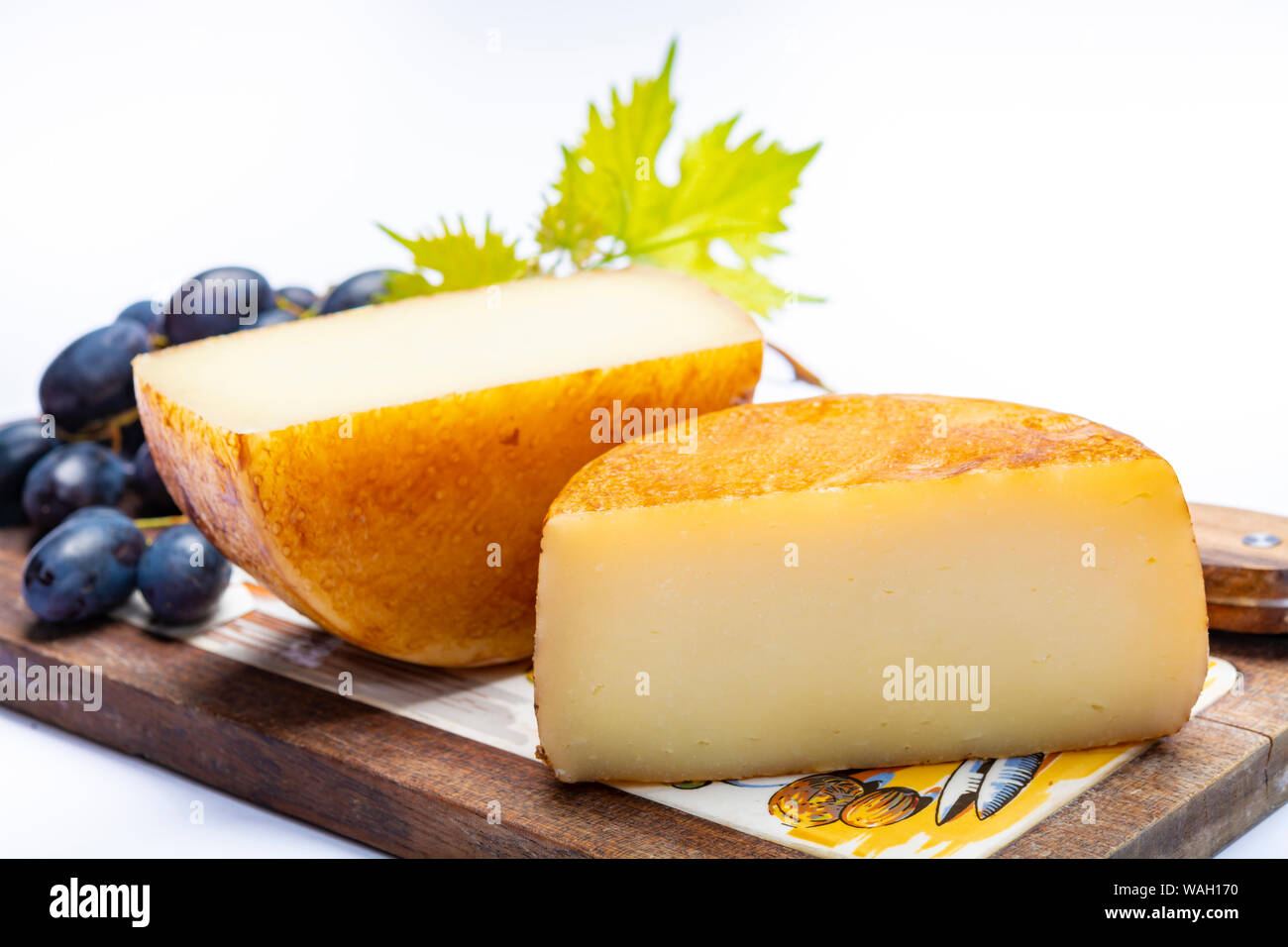 Hard Italian pecorino sheep cheese in two pieces close up isolated