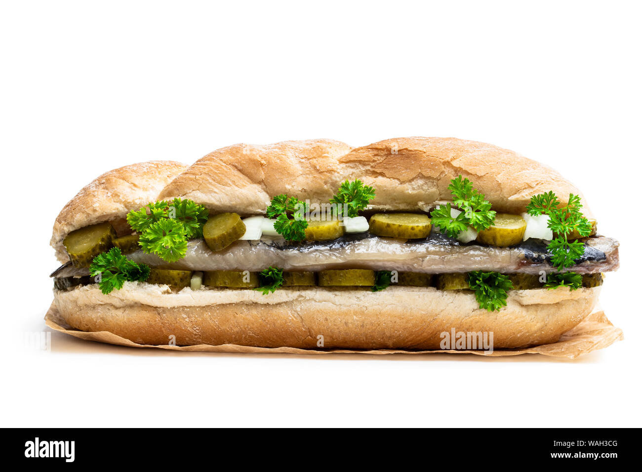 Traditional Dutch sandwich with herring and pickles isolated on white