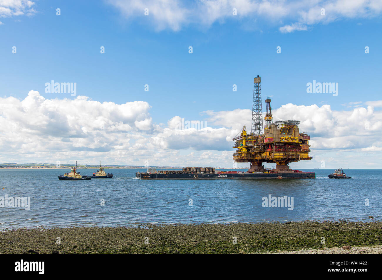 After over 40 years of oil production, the decommissioned Brent Bravo oil rig is towed into the River Tees estuary to be broken up for scrap. Stock Photo