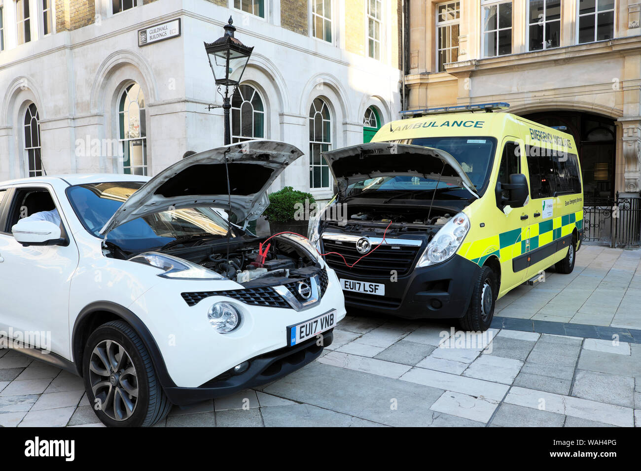 NHS ambulance charging a car battery with jump leads in Guildhall yard City of London England UK  KATHY DEWITT Stock Photo